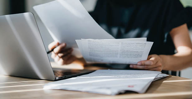 Cropped shot of young Asian woman handling personal banking and finance with laptop at home. Planning budget and calculating expenses. Managing taxes and financial bills. Wealth management. Digital banking habits. Smart banking with technology