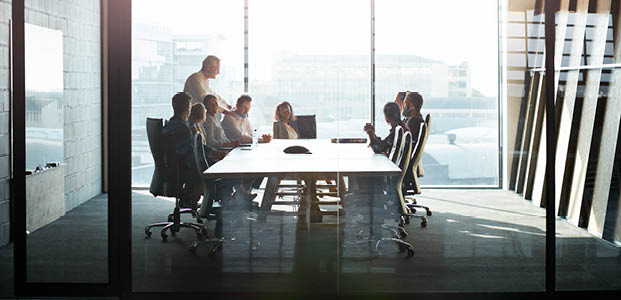 CEO giving peptalk to businesspeople at meeting in big conferenceroom