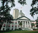 Tallahassee's Old Capitol, built circa 1845, incorporates a Greek Revival portico. The new capitol building stands in the background.