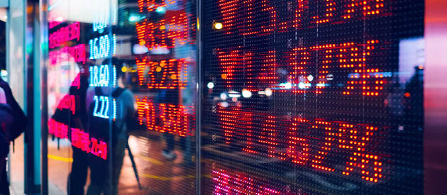Stock exchange market display screen board on the street showing stock market crash sell-off in red colour